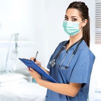 Travel Nurse in surgical mask preparing for shift in Kansas