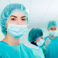 Scrub Tech in surgical mask preparing for shift in Kansas